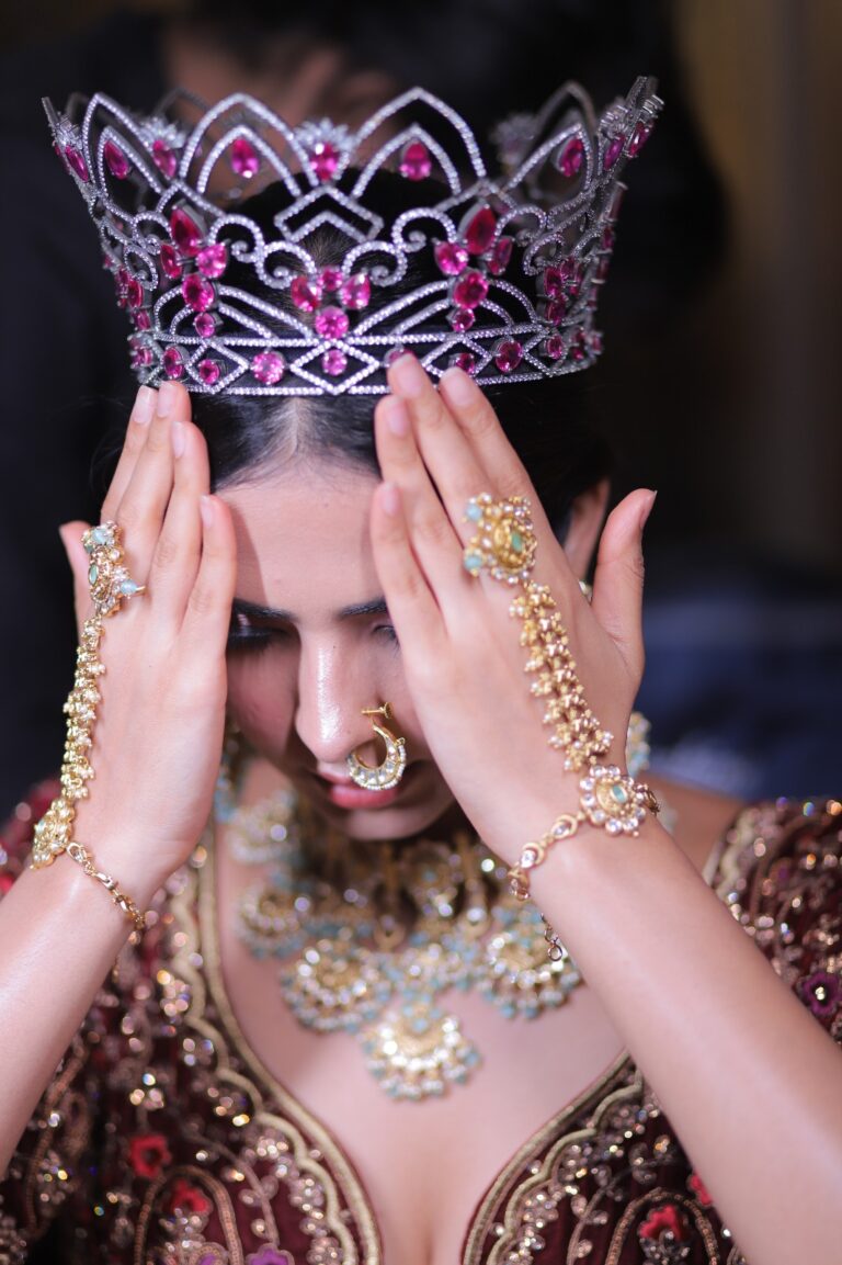 woman wearing a tiara covering her eyes