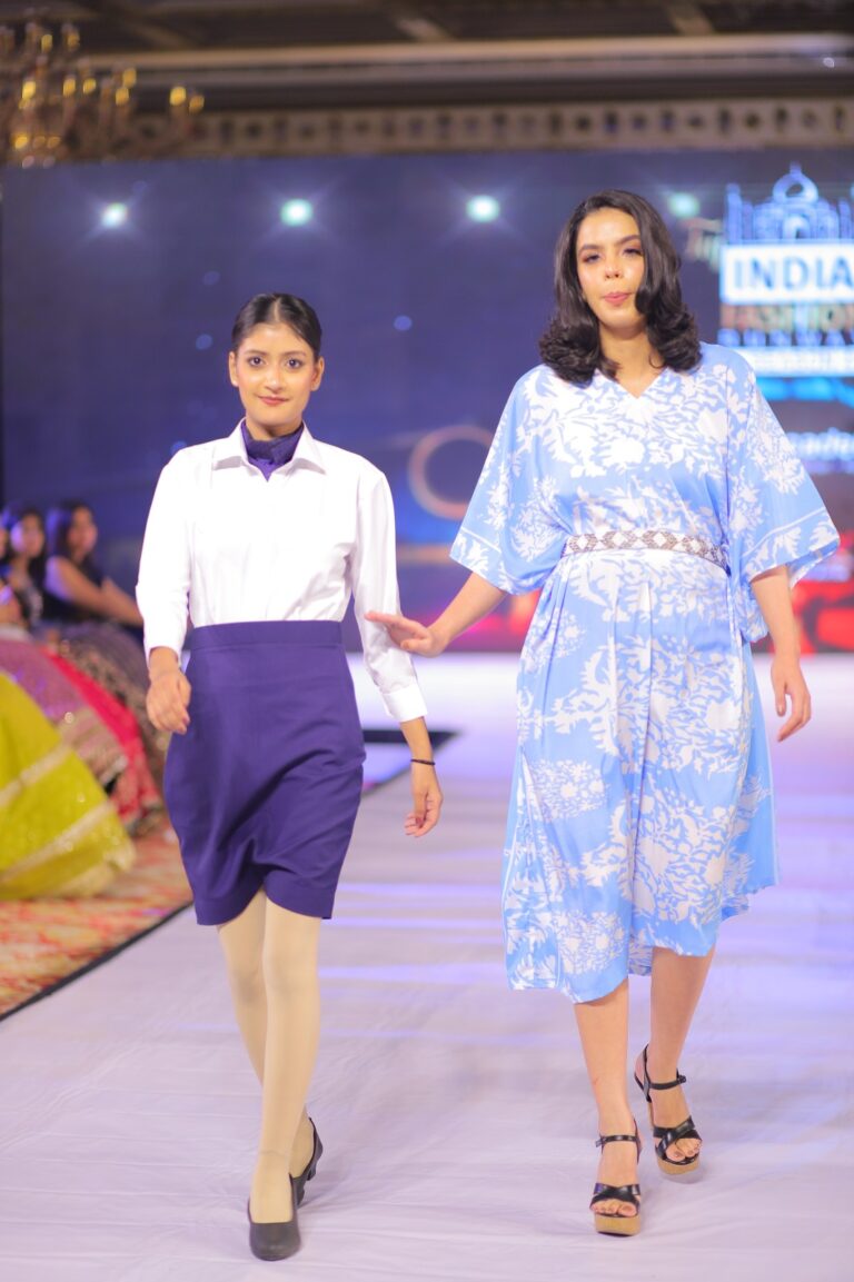 two women walking on fashion show